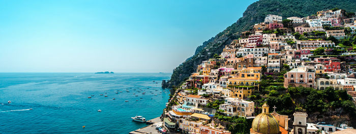 High angle view of townscape by sea against sky