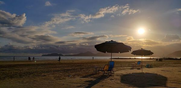 Scenic view of beach against sky during sunset