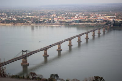 High angle view of bridge over river by buildings in city