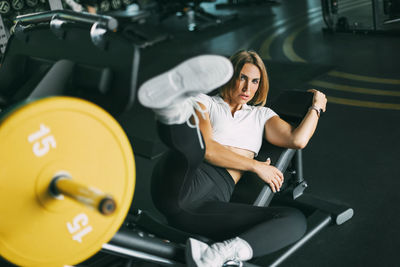 Young woman exercising in gym