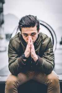 Close-up portrait of man smoking outdoors