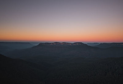 Scenic view of silhouette mountains against sky during sunset