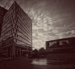 Buildings against cloudy sky