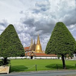 Temple by building against sky