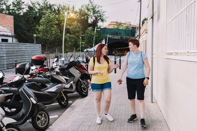 Rear view of woman walking on road