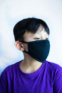 Close-up of boy wearing mask