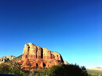 Low angle view of rock formation against blue sky