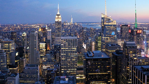 Empire state building and bank of america tower amidst illuminated city