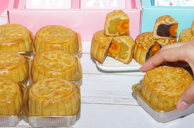 Close-up of hand holding food on table