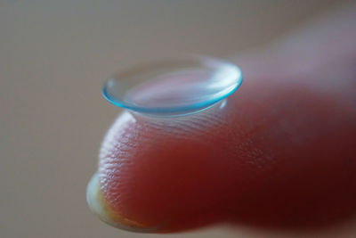 Close-up of human hand against blue background