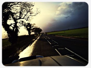 Country road passing through car windshield