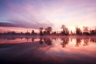 Scenic view of lake against sky during sunset