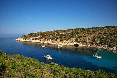 Deep bay in adriatic sea with sailboats anchored in clear blue water