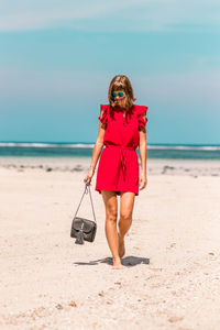 Full length of woman standing at beach