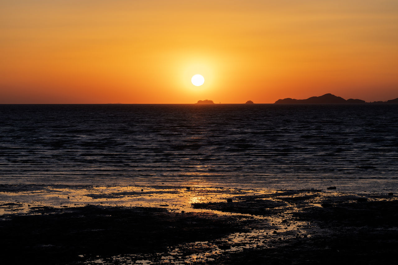 sunset, sky, sea, water, beauty in nature, scenics - nature, tranquility, sun, nature, land, orange color, tranquil scene, horizon, horizon over water, ocean, afterglow, sunlight, beach, idyllic, dramatic sky, environment, no people, coast, travel destinations, seascape, wave, dawn, landscape, silhouette, travel, outdoors, motion, cloud, evening, shore, reflection, urban skyline, vacation, trip, atmospheric mood, non-urban scene, tourism, holiday, romantic sky, wind wave, awe, summer