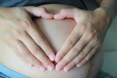 Close-up of father holding hands