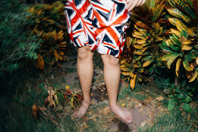 Low section of woman standing on leaves