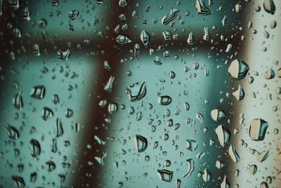 Full frame shot of wet glass window in rainy season