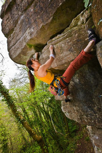 Female climber on a difficult climb in the wye valley in south wales