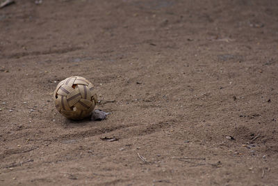 High angle view of abandoned soccer ball on sand