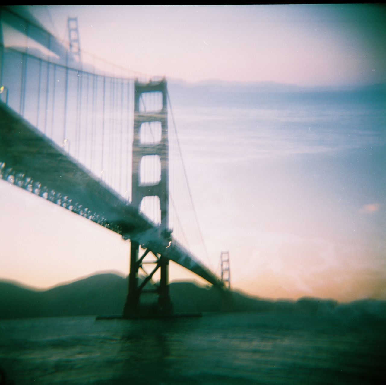 sky, bridge, connection, bridge - man made structure, architecture, suspension bridge, built structure, auto post production filter, water, nature, no people, cloud - sky, outdoors, transportation, sea, sunset, day, low angle view, bay