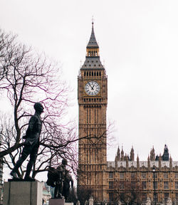 Low angle view of clock tower against sky