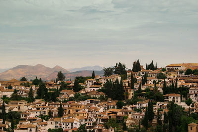 Buildings in town against sky