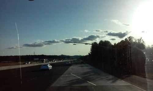 Road passing through sunset