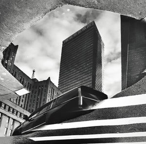 Low angle view of modern buildings against sky in city