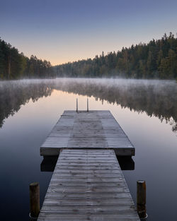 Pier over lake against sky