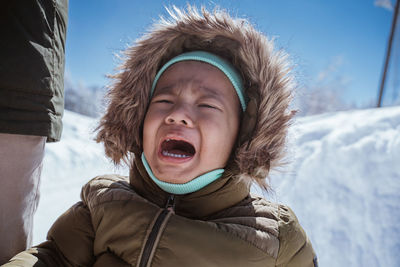 Portrait of smiling young woman in snow