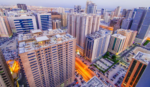 Aerial view of skyscrapers in city during sunset