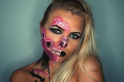 Close-up portrait of beautiful young woman against white background