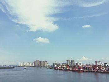 Scenic view of sea by buildings against sky