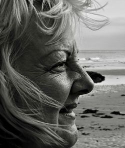 Close-up of woman looking away at beach