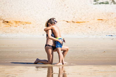 Mother and son hugging on a beach