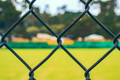 Close-up of chainlink fence against sky