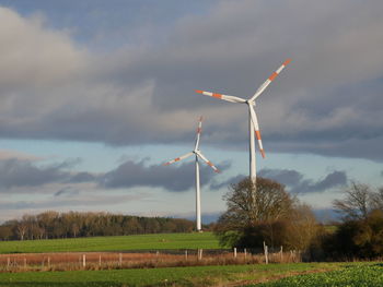 Windmill on field against sky