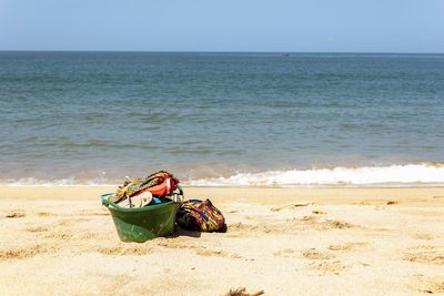 Deck chairs on beach against clear sky