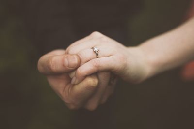 Midsection of couple holding hands