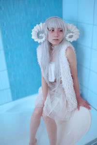 Portrait of young woman in bathtub