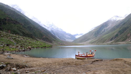 Scenic view of saifulmaluk lake and mountains against sky