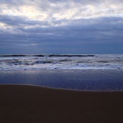 Scenic view of beach against sky during sunset