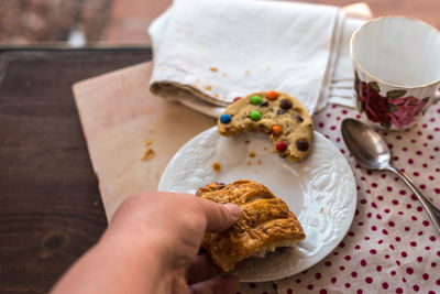 High angle view of hand holding food in plate