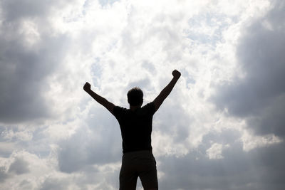 Rear view of man standing against sky