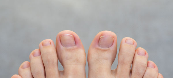 Cropped hand of person against black background