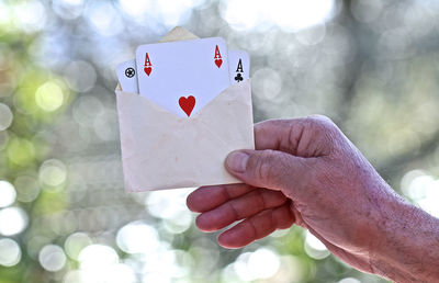 Close-up of hand holding heart shape paper