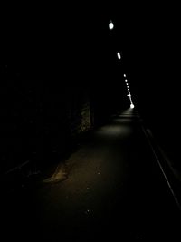 Illuminated road against sky at night
