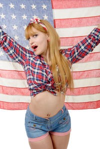 Portrait of beautiful young woman holding american flag