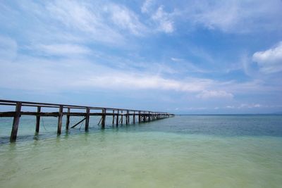 Pier over sea against sky